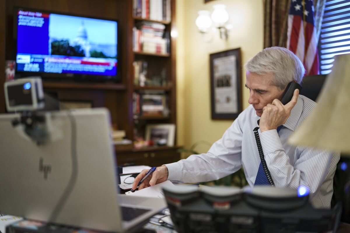 Sen. Rob Portman, R-Ohio, the top Republican negotiator on the bipartisan infrastructure bill, works from his office on Capitol Hill as he continues to shepherd the $1 trillion legislation closer to passage, in Washington, Monday, Aug. 9, 2021. (AP Photo/J. Scott Applewhite)