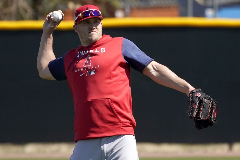 Los Angeles Angels' Mike Trout throws during the teams' spring training baseball workouts.