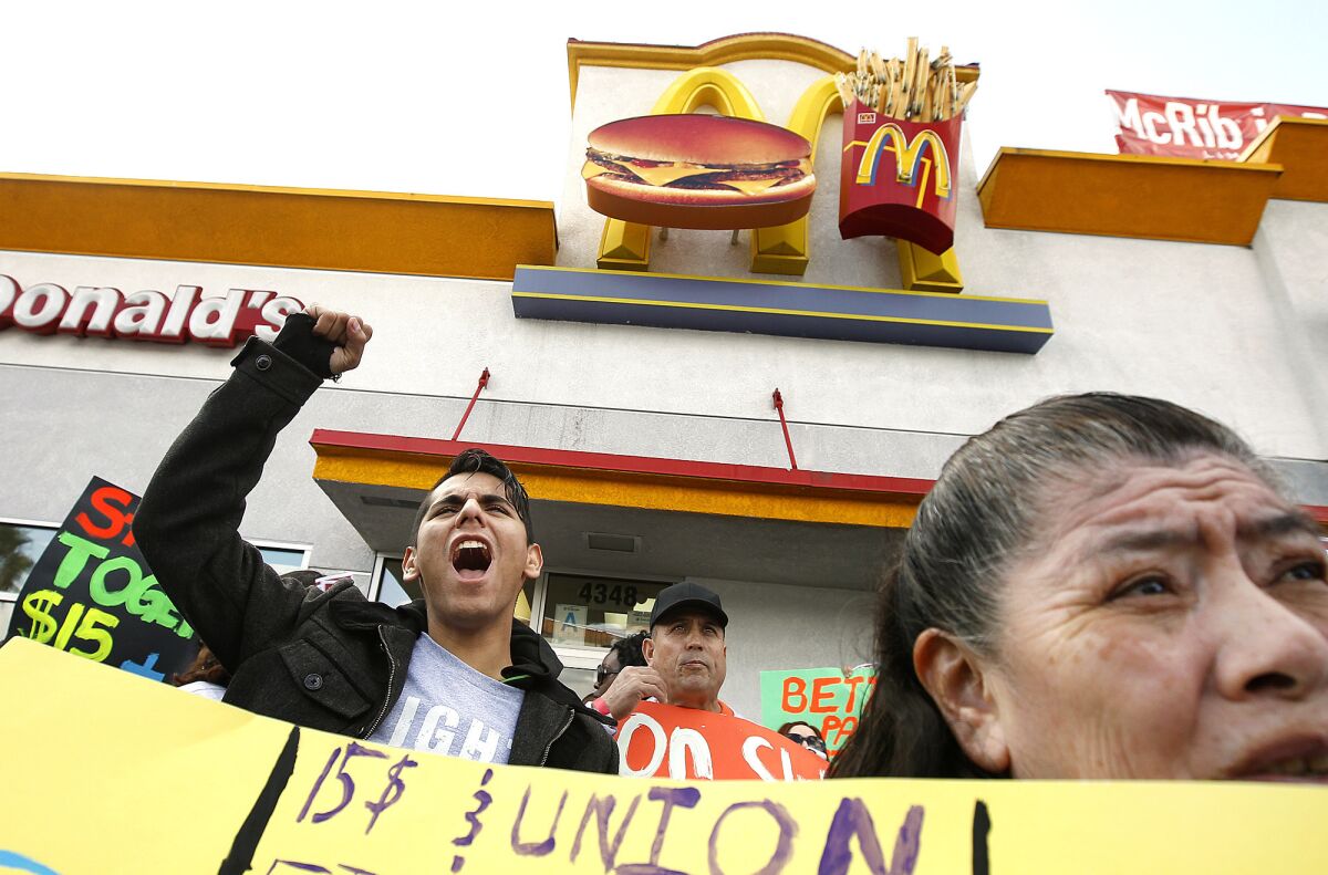 Protesters demanding a $15-an-hour minimum wage demonstrate outside a McDonald's restaurant in Los Angeles last December.