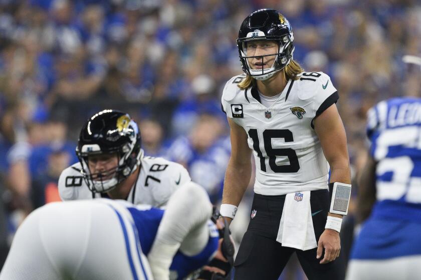 Jacksonville Jaguars quarterback Trevor Lawrence (16) looks over the defense during an NFL football game against the Indianapolis Colts, Sunday, Sept. 10, 2023, in Indianapolis. (AP Photo/Zach Bolinger)