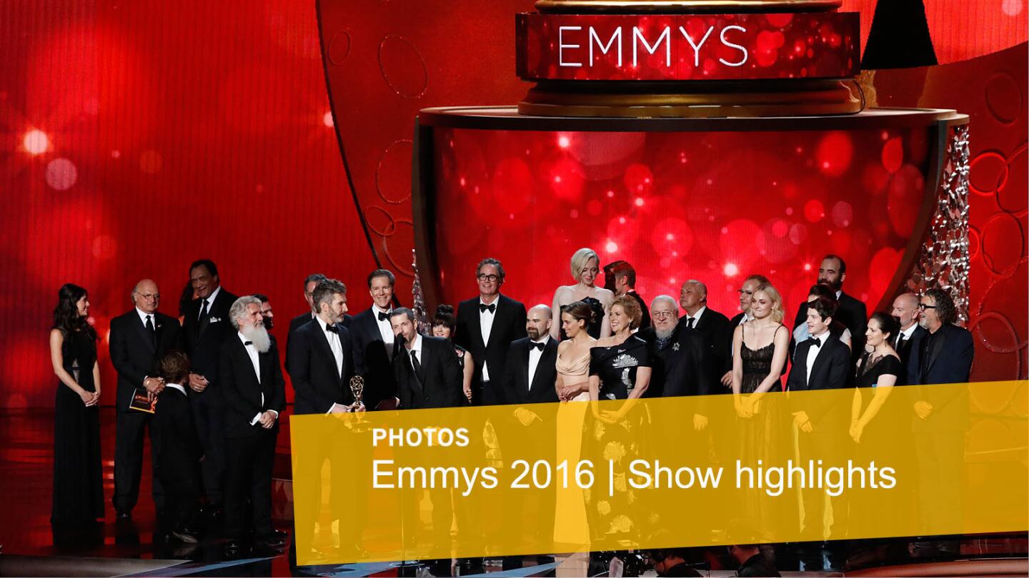 D.B. Weiss at the microphone and David Benioff, at left of Weiss, accept the Emmy for Drama Series for "Game of Thrones" with the cast and crew.