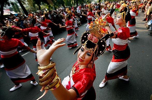 Dancers perform in a parade celebrating the 64th anniversary of Indonesia's independence.