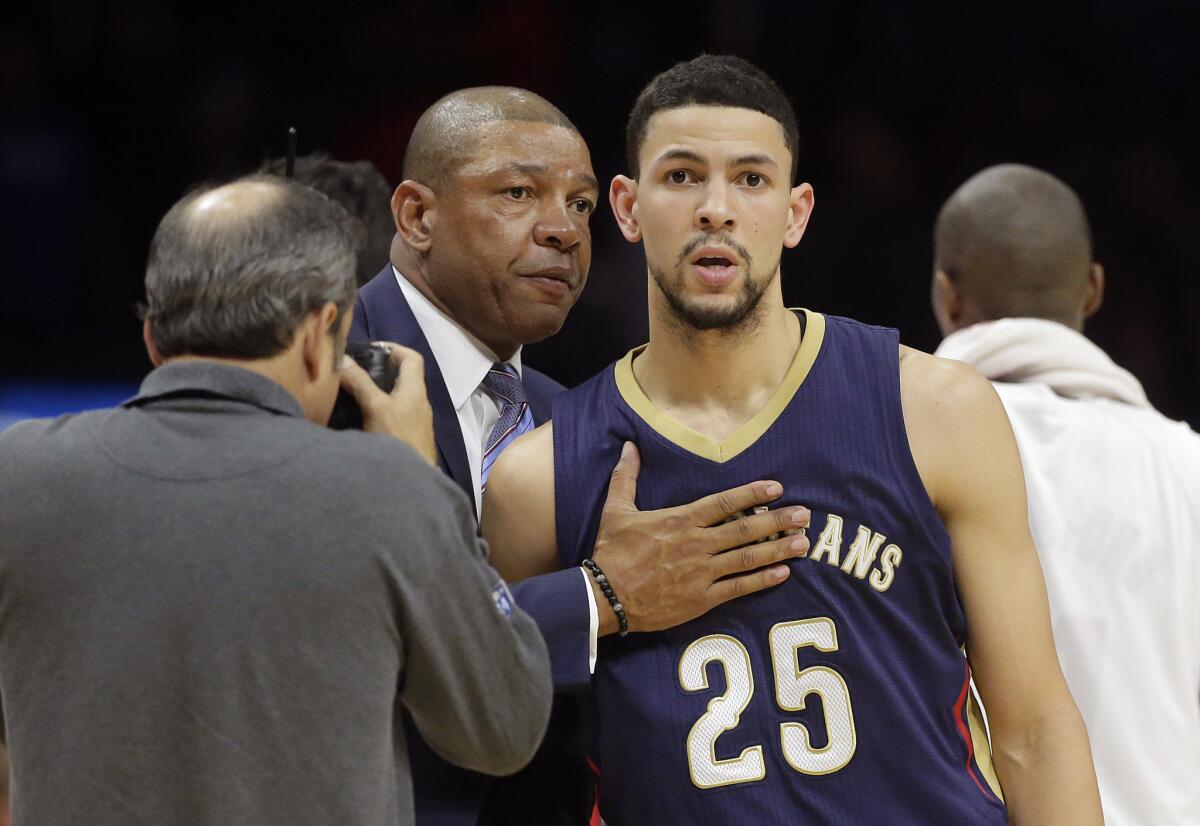 Clippers Coach Doc Rivers, left, hugs his son, New Orleans guard Austin Rivers, after L.A. beat the Pelicans, 120-100, on Dec. 6 at Staples Center.