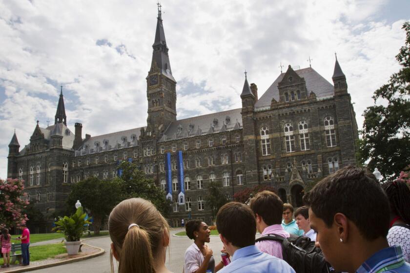 FILE - In this July 10, 2013, file photo, prospective students tour Georgetown University's campus in Washington. Georgetown University undergraduates have voted Thursday, April 11, 2019, in favor of a referendum seeking the establishment of a fund benefiting the descendants of enslaved people sold to pay off the school's debts. (AP Photo/Jacquelyn Martin, File)