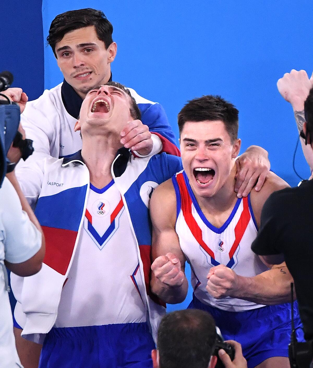 ROC men's gymnastics team members react after winning Olympic gold Monday in Tokyo. 