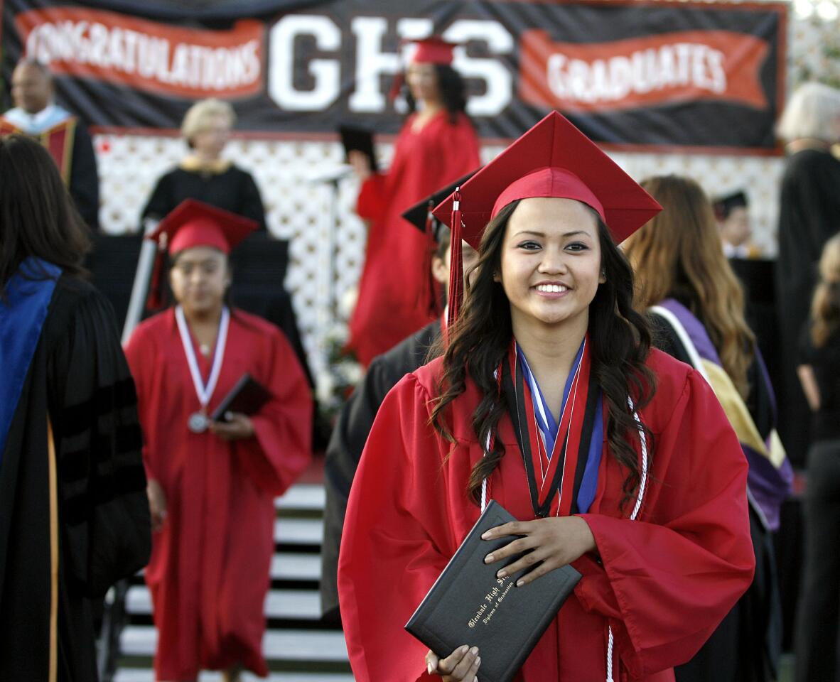 Yvonne Cuaresma celebrates graduating from Glendale High School at the school's field in Glendale on Thursday, June 14, 2012. Six-hundred and fifty-six students graduated from the school today.