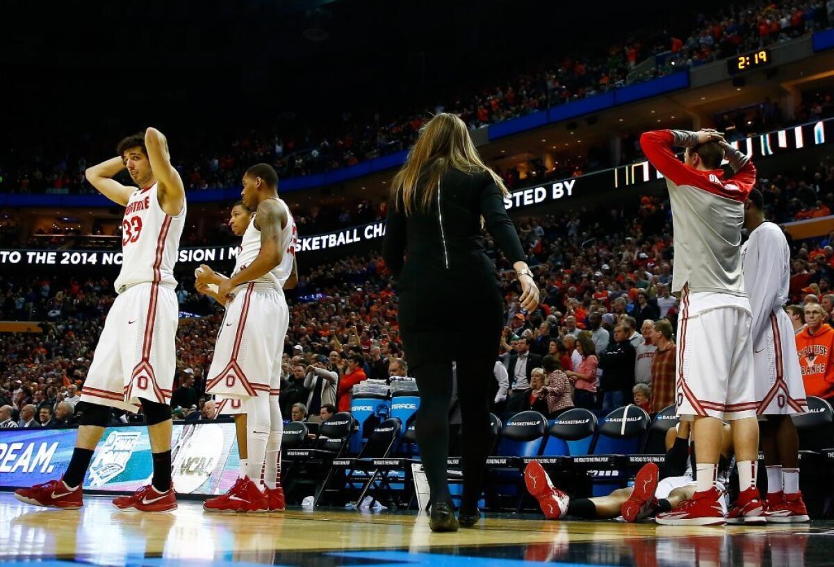 Members of Ohio State react after the loss to Dayton.