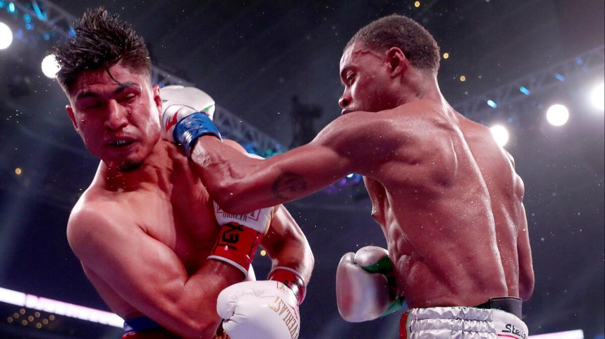 Errol Spence Jr. lands a blow against Mikey Garcia in an IBF World Welterweight Championship bout at AT&T Stadium on March 16, 2019 in Arlington, Texas.
