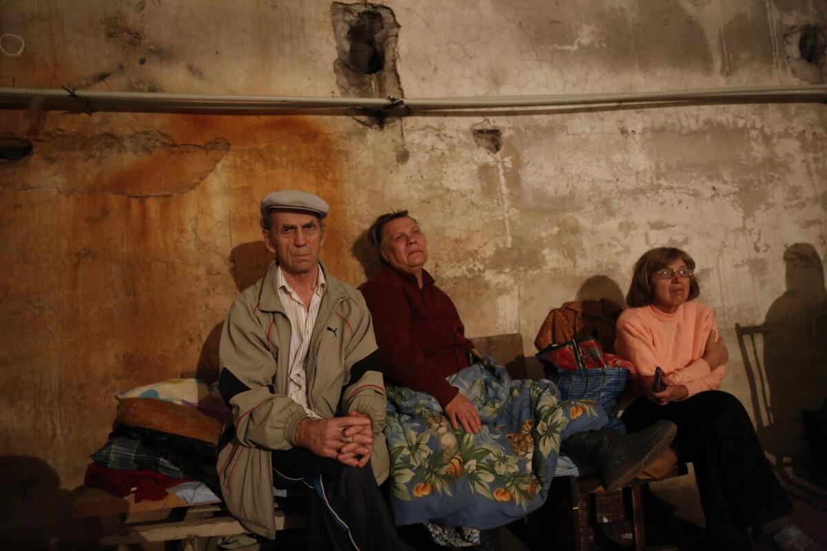 Residents of Donetsk, in eastern Ukraine, sit in a basement where they took shelter during shelling in the city Aug. 20.