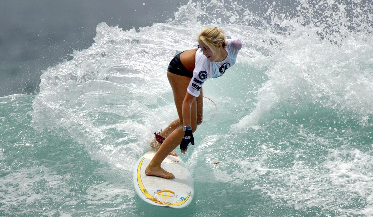 Bethany Hamilton carves up a wave during a surfing competition in June 2004, months after a shark attack cost her her left arm.