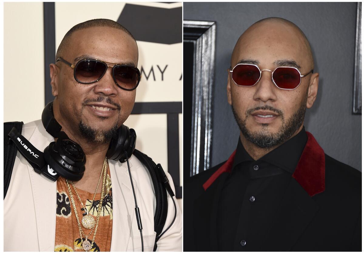 Timbaland wears headphones around his neck, Swizz Beatz wears a black suit. Both wear sunglasses.