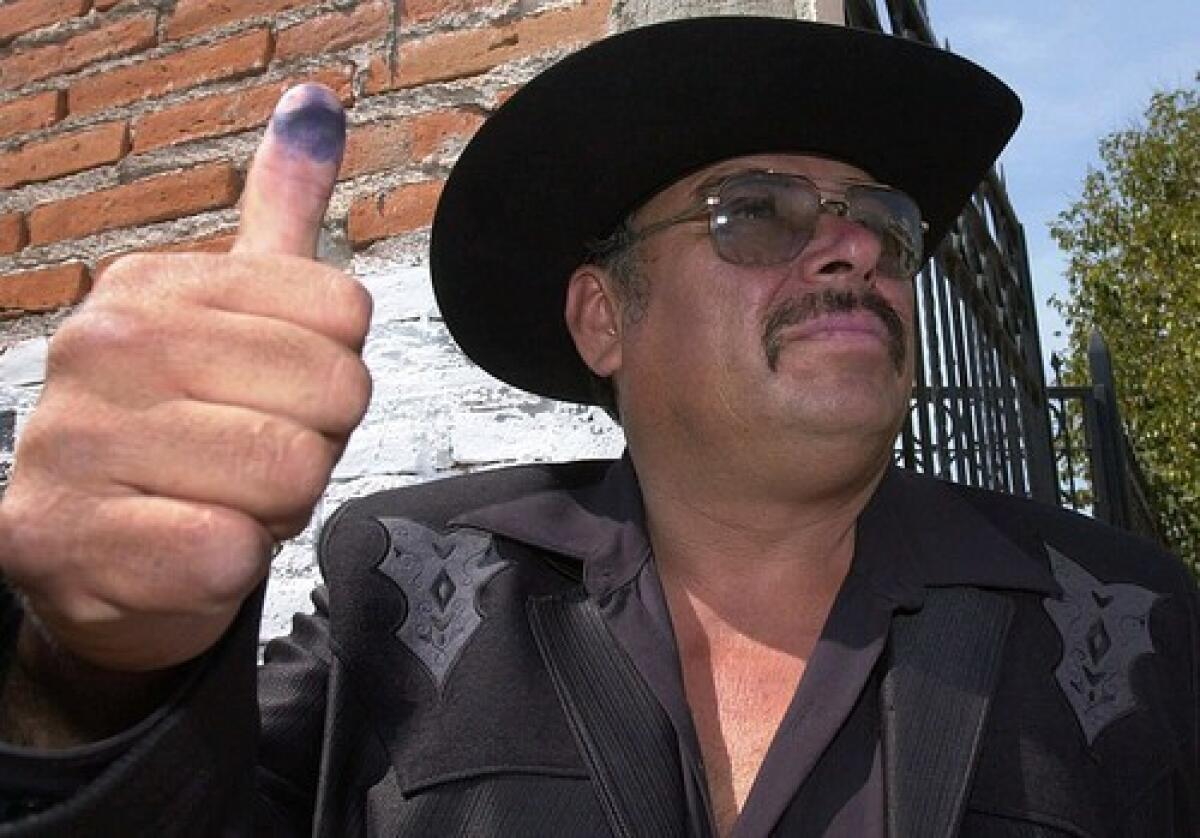 Andres Bermudez shows his thumb after casting his vote in Jerez, Mexico, where he was elected mayor in 2001.