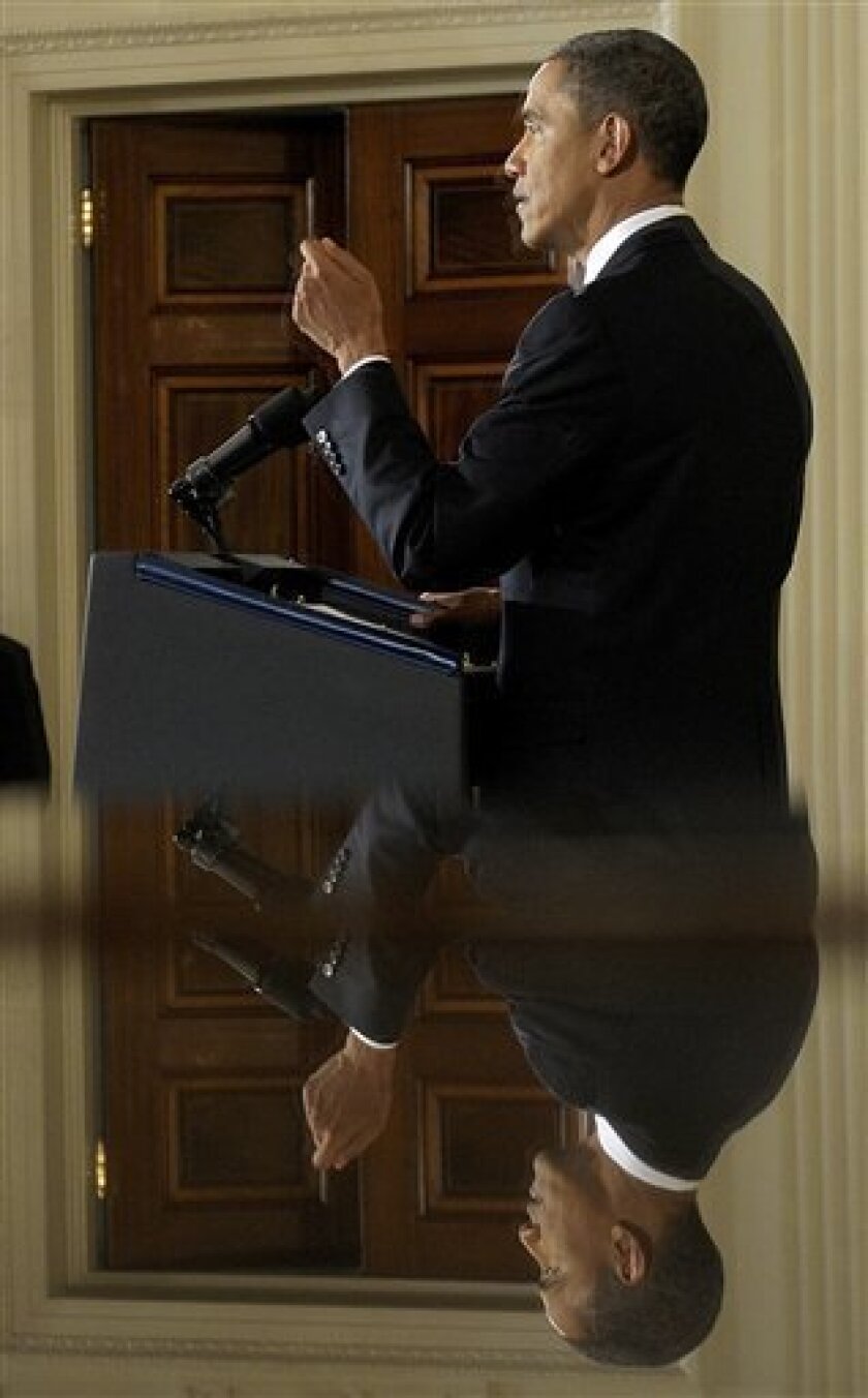 President Barack Obama is reflected in the mirror as he answers questions during a news conference in the East Room of the White House in Washington, Friday, Sept. 10, 2010. (AP Photo/Susan Walsh)