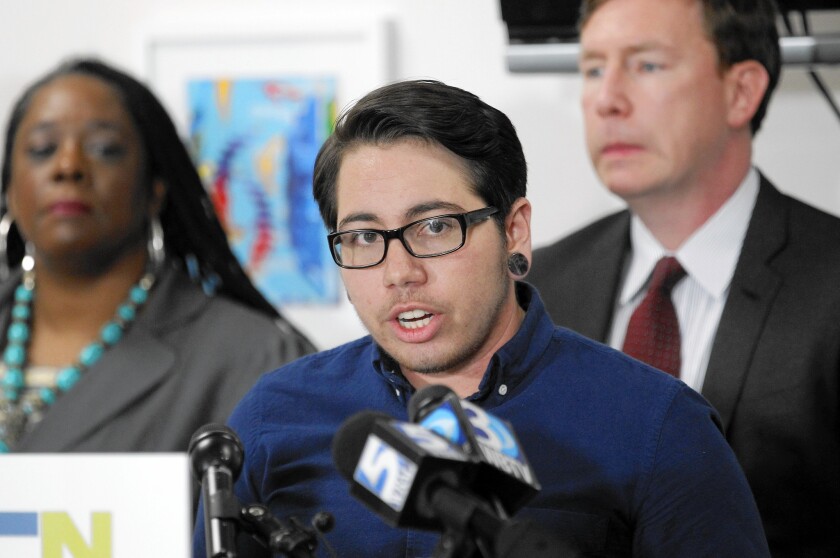 Lead plaintiff Joaquin Carcano at a news conference to announce the filing of a federal lawsuit challenging North Carolina's anti-gay law. Simone Bell of Lambda Law and the ACLU's Chris Brook are behind him.