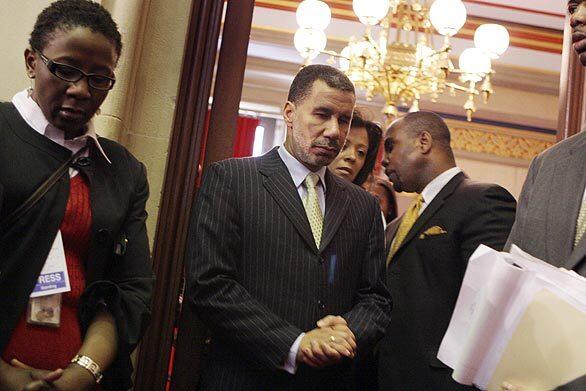 New York Lt. Gov. David Paterson, center, prepares to be sworn in as governor in Albany on Monday. Paterson takes over for Eliot Spitzer, who resigned in a sex scandal.