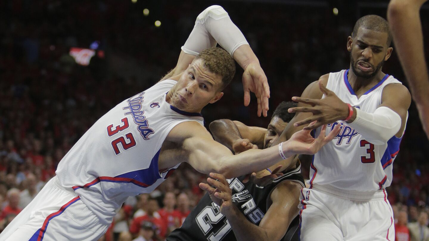 Clippers forward Blake Griffin, left, and point guard Chris Paul, right, battle San Antonio Spurs forward Tim Duncan for the ball during the Clippers' 111-109 victory in Game 7 of the NBA Western Conference quarterfinals at Staples Center on May 2, 2015.