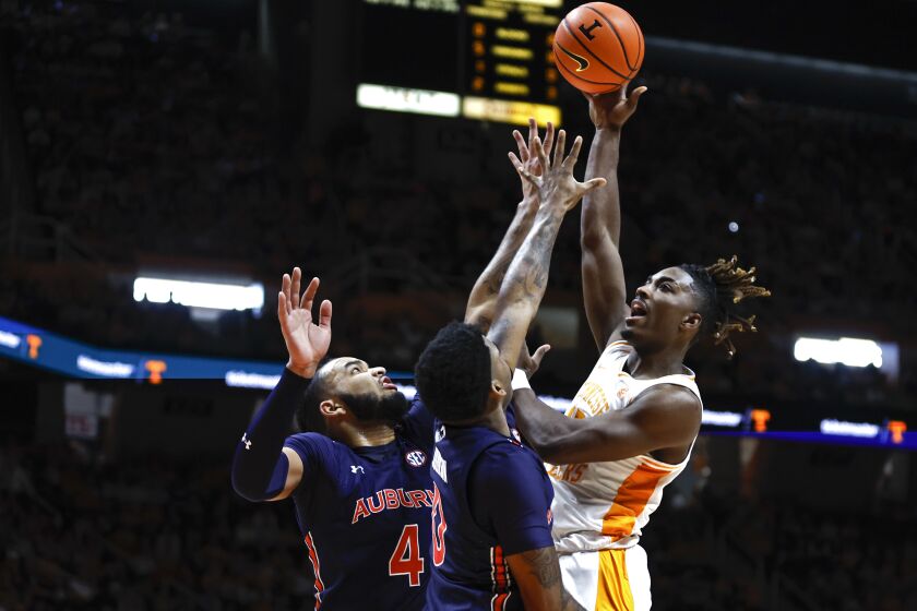 Tennessee guard Jahmai Mashack (15) shoots over Auburn forward Johni Broome (4) and guard K.D. Johnson during the first half of an NCAA college basketball game, Saturday, Feb. 4, 2023, in Knoxville, Tenn. (AP Photo/Wade Payne)