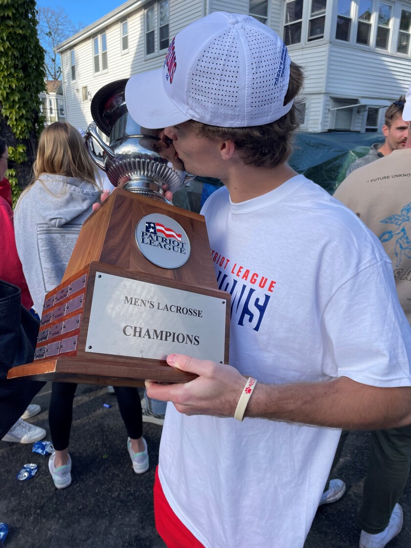 Dane DeGoler with the Patriot League championship trophy.