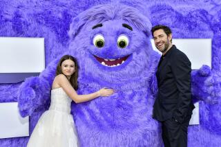 Cailey Fleming, left, and John Krasinski pose with the character "Blue" at the premiere of Paramount Pictures' "IF" at the SVA Theatre on Monday, May 13, 2024, in New York. (Photo by Evan Agostini/Invision/AP)