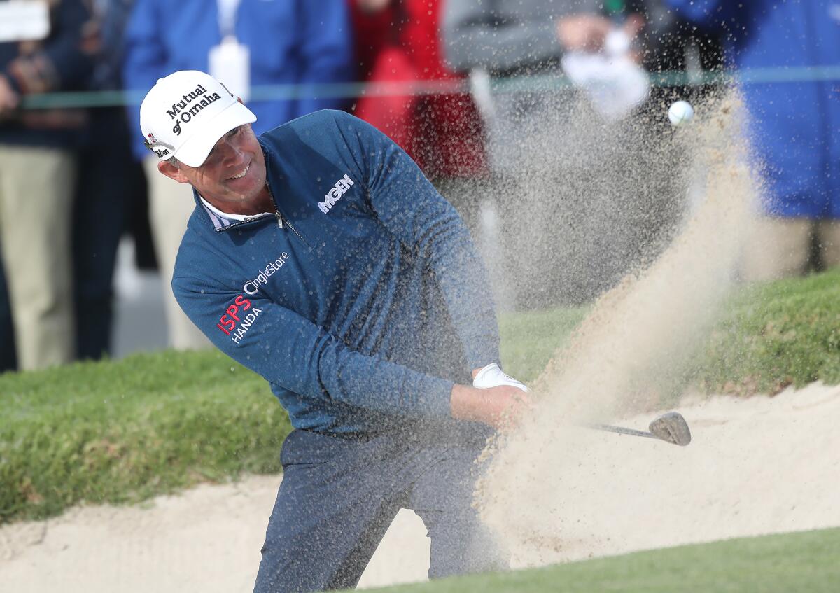 Padraig Harrington hits from the green-side bunker and puts it close to the pin on the 18th hole Sunday.