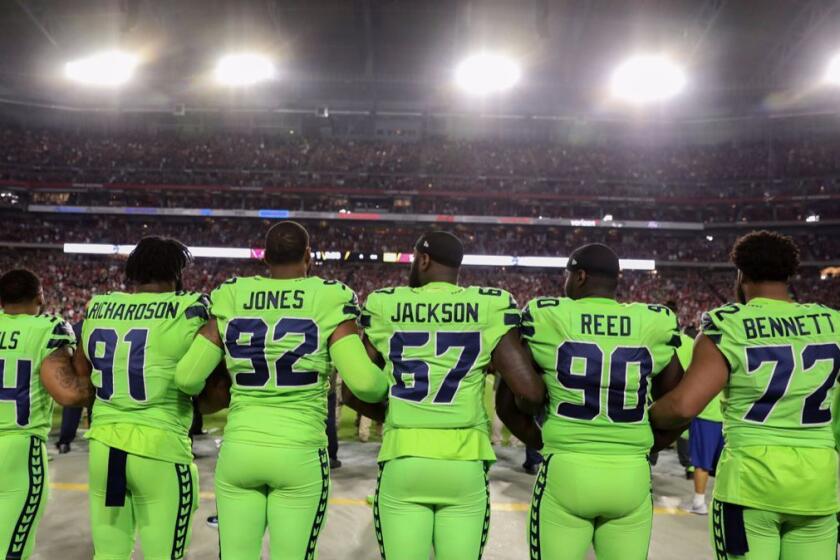 GLENDALE, AZ - NOVEMBER 09: Running back Thomas Rawls #34, defensive tackle Sheldon Richardson #91, defensive tackle Nazair Jones #92, defensive end Branden Jackson #67, defensive tackle Jarran Reed #90 and defensive end Michael Bennett #72 of the Seattle Seahawks link arms during the national anthem for the NFL game against the Arizona Cardinals at University of Phoenix Stadium on November 9, 2017 in Glendale, Arizona. (Photo by Christian Petersen/Getty Images) ** OUTS - ELSENT, FPG, CM - OUTS * NM, PH, VA if sourced by CT, LA or MoD **