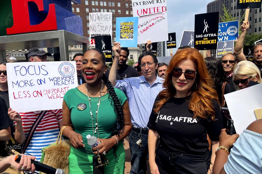 Actors Sheryl Lee Ralph, left, and Lisa Ann Walter, members of the cast of "Abbott Elementary," participate in a rally 