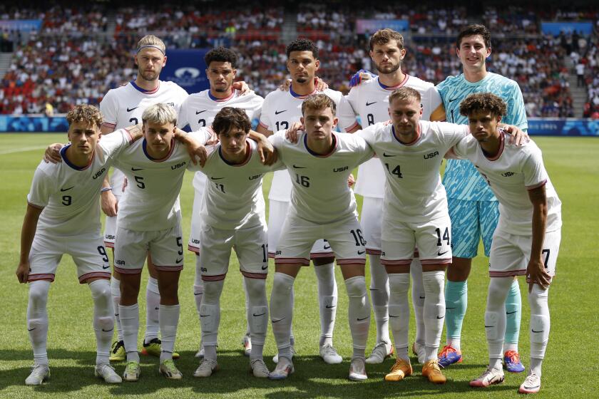 The United States team pose for a group photo before the quarterfinal men's soccer match.