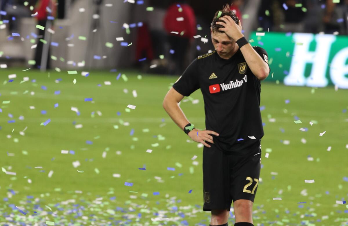 LAFC defender Tristan Blackmon walks off the field confetti rains down.