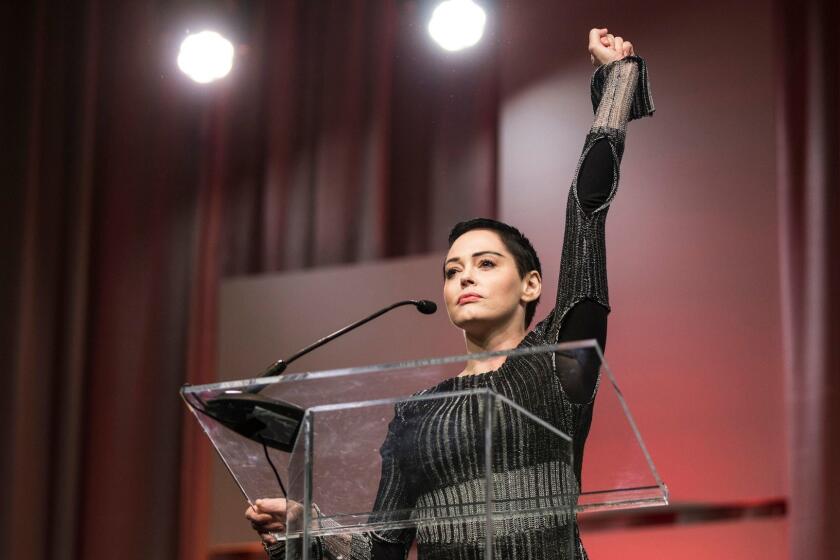 Rose McGowan raises her fist as she speaks during The Women's Convention at Cobo Center in downtown Detroit, Friday, Oct. 27, 2017. (Junfu Han/Detroit Free Press/TNS via Getty Images)