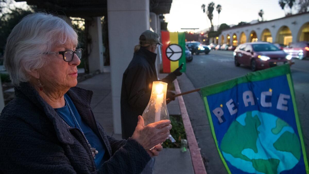 Marqui Bury holds a candle at a weekly Friday night peace vigil along Ojai Avenue in downtown Ojai.