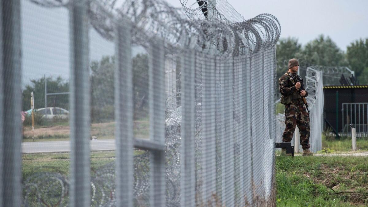 A Hungarian soldier patrols at the transit zone at Hungary's southern border with Serbia in September 2016.