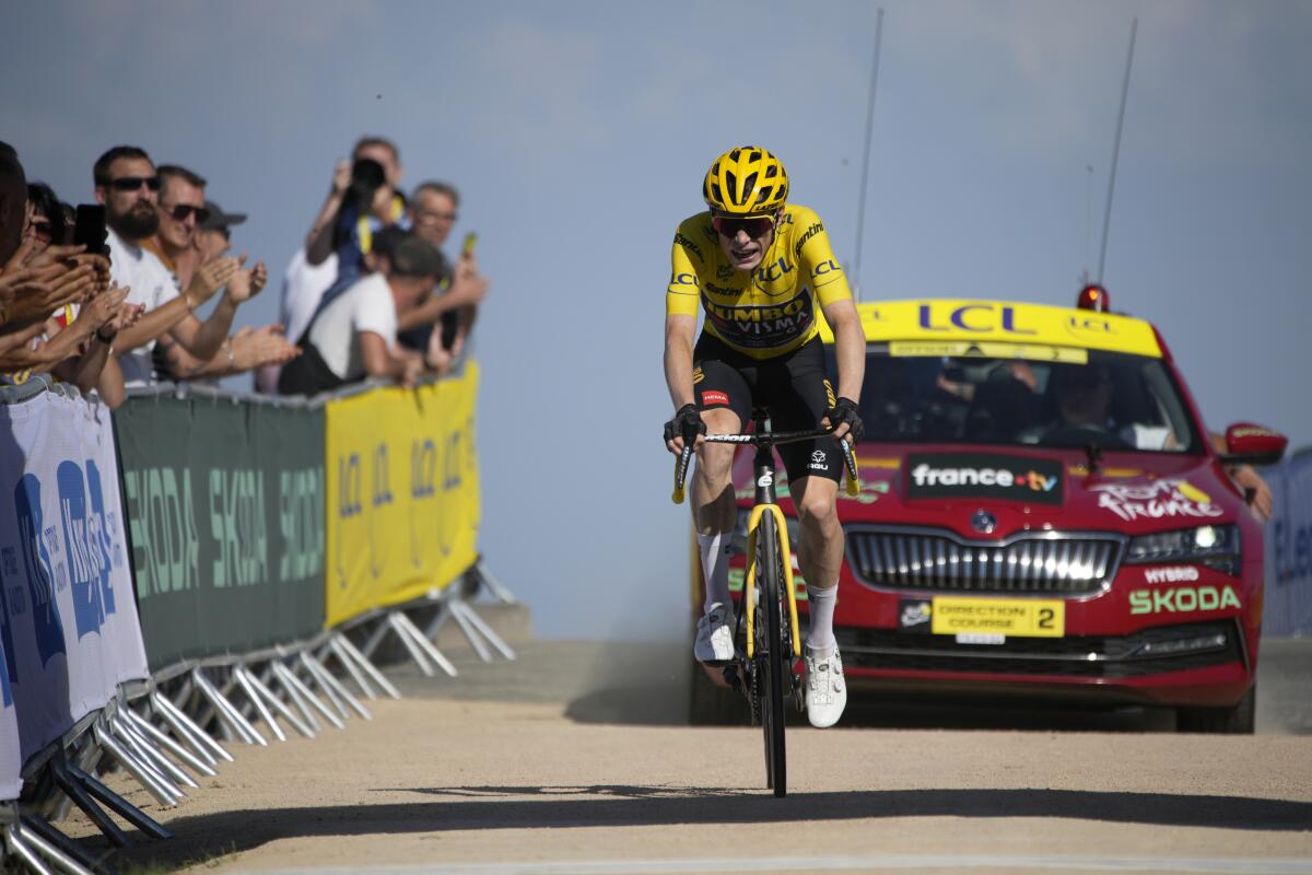 Jonas Vingegaard, wearing the overall leader's yellow jersey, approaches the finish of the Tour de France's ninth stage.