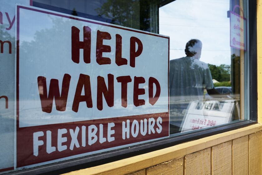 Help wanted sign is displayed in Deerfield, Ill., Wednesday, Sept. 21, 2022. The number of available jobs in the U.S. plummeted in August compared with July, a sign that businesses may pull back further on hiring and potentially cool chronically high inflation. There were 10.1 million advertised jobs on the last day of August, the government said Tuesday, Sept. 4, down a huge 10% from 11.2 million openings in July. In March, job openings had hit a record of nearly 11.9 million. (AP Photo/Nam Y. Huh)