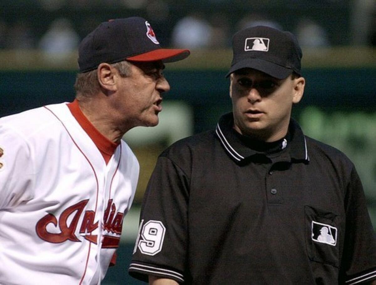 As first-base coach for the Cleveland Indians, Ted Uhlaender expresses himself to an umpire. He began his professional life as an outfielder and most recently scouted for the San Francisco Giants.