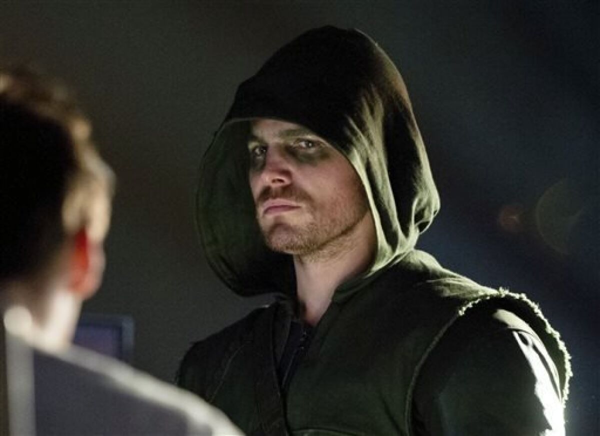 This publicity image released by The CW shows Stephen Amell as Oliver Queen/Arrow in a scene from "Arrow." (AP Photo/The CW, Cate Cameron)