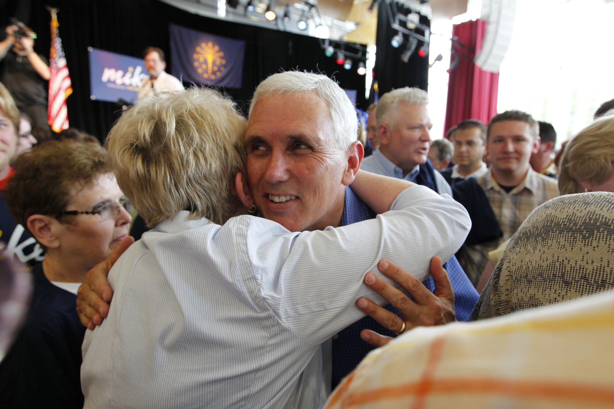 Then-Rep. Mike Pence hugs one of many supporters at a 2011 event in Columbus, Ind., to kick off his gubernatorial run.