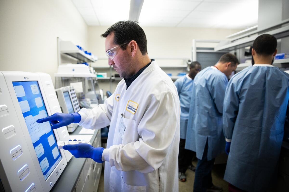A technician at UC Davis loads a sample into GenMark Diagnostics' ePlex analyzer. 