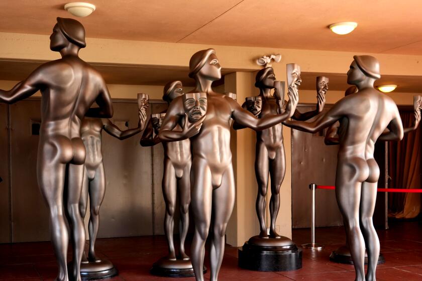 Actor statues stand outside an entrance to the Shrine Auditorium, the site of Saturday's 30th Screen Actors Guild Awards