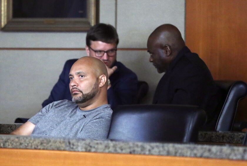 FILE - In this Aug. 23, 2019 file photo, former Houston police officers Steven Bryant, foreground, and Gerald Goines, background, turn themselves in at the Civil Courthouse, in Houston. Bryant, pleaded guilty Tuesday, June 1, 2021, to federal charges in the deaths of two homeowners killed in a 2019 drug raid, admitting he lied and obstructed the resulting investigation. (Karen Warren/Houston Chronicle via AP, File)