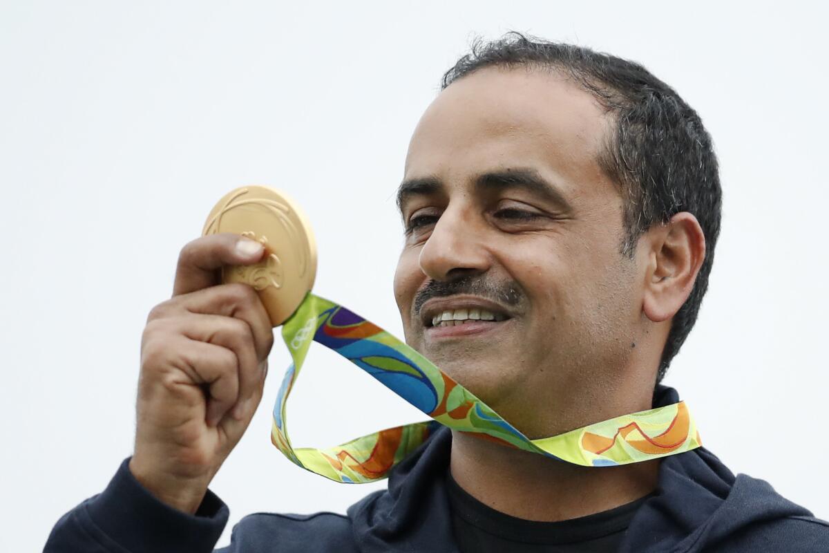 Fehaid Deehani looks at his gold medal.