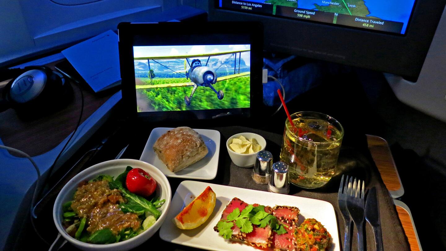 Dinner is served in business class aboard an American Airlines flight from London to Los Angeles.