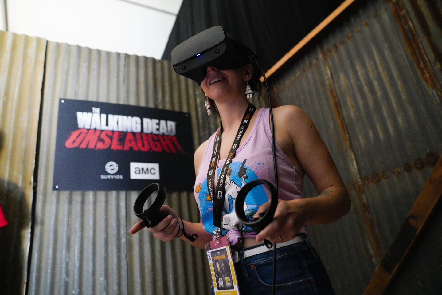 Lyndsay Winkley takes the new VR game for a test drive at "The Walking Dead" exhibit just outside the main convention center in downtown San Diego.