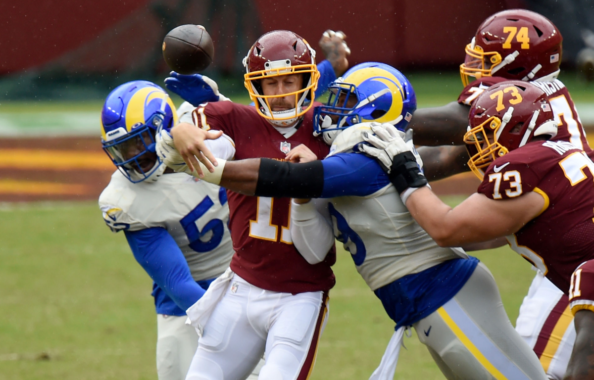Washington quarterback Alex Smith is hit by Rams defensive end Aaron Donald.