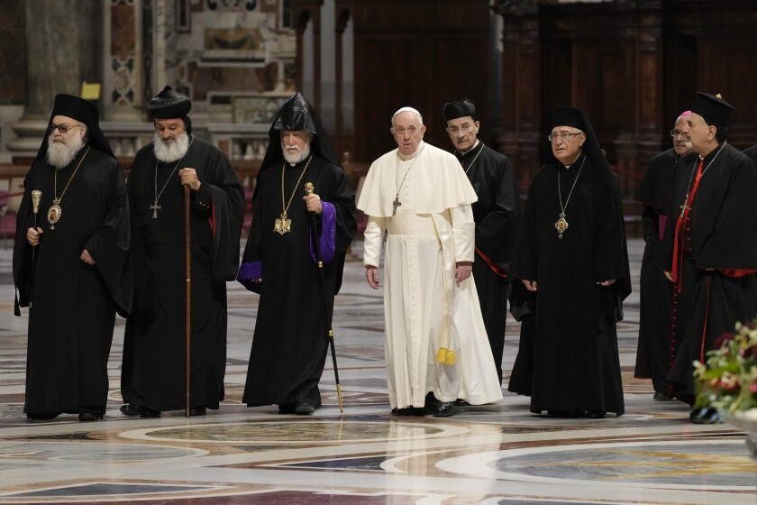 The Patriarch of the Syriac Orthodox Church, Moran Mor Ignatius Aphrem II, second from left, the head of the Catholicosate of the Great House of Cilicia of the Armenian Apostolic Church, Aram I, third from left, Pope Francis, fourth from left, Cardinal Bechara Boutros al-Rahi, firfth from left, Patriarch of Antioch and All the East for the Syriac Catholic Church, Ignatius Youssef III Younan, right, arrive in St. Peter's Basilica to attend a prayer for Lebanon at the Vatican, Thursday, July 1, 2021. (AP Photo/Gregorio Borgia)
