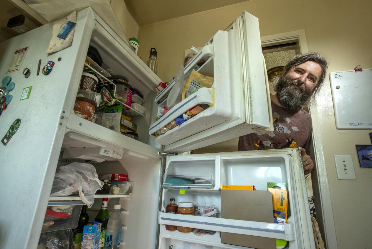 Josh Steichmann is photographed next to his refrigerator 