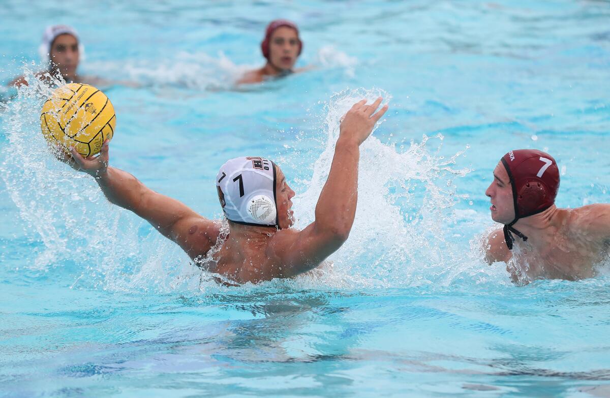 Zach Bettino (7) pulls back to shoot in a Surf League boys' water polo match against Laguna Beach on Wednesday.