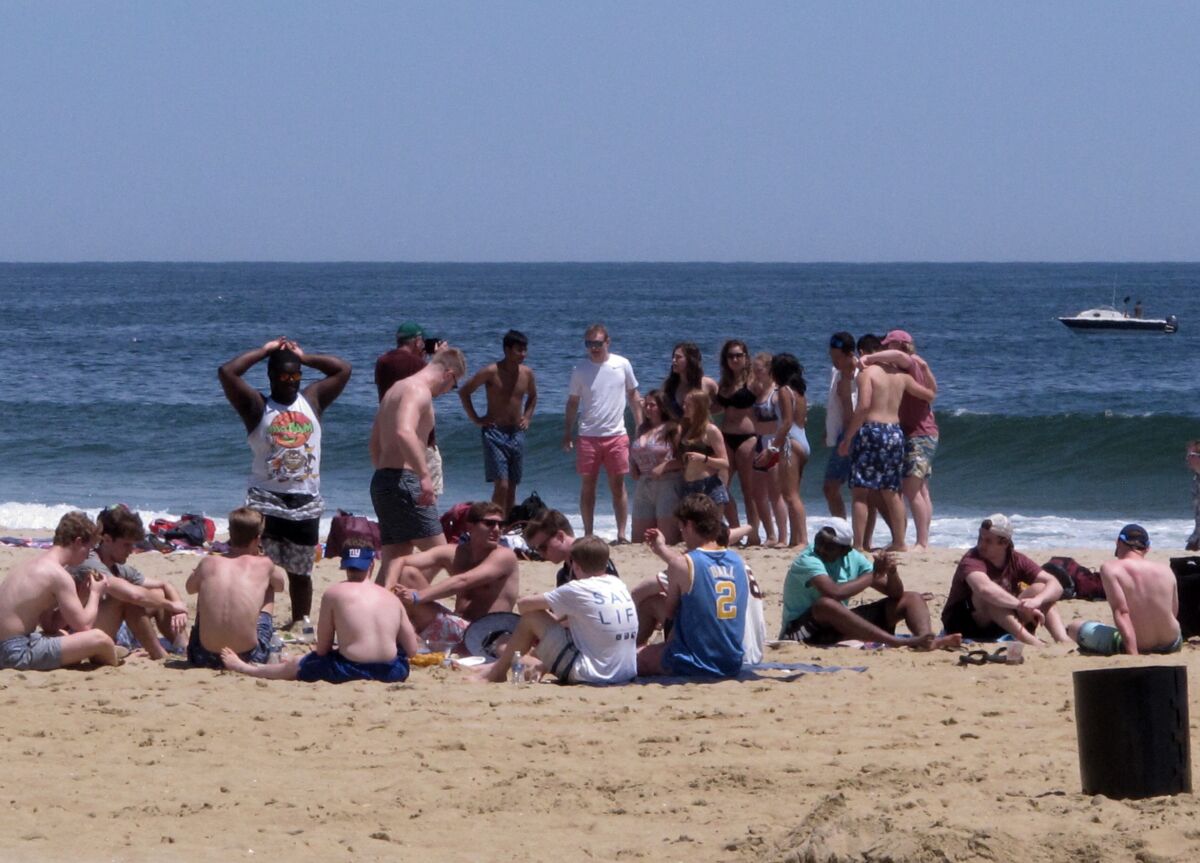 FILE - Beachgoers enjoy an afternoon on the sand in Point Pleasant Beach,N.J. on May 21, 2018. Judges issued rulings on Thursday, June 16, 2022 blocking so-called pop-up parties from being held in Long Branch and Point Pleasant Beach. (AP Photo/Wayne Parry)
