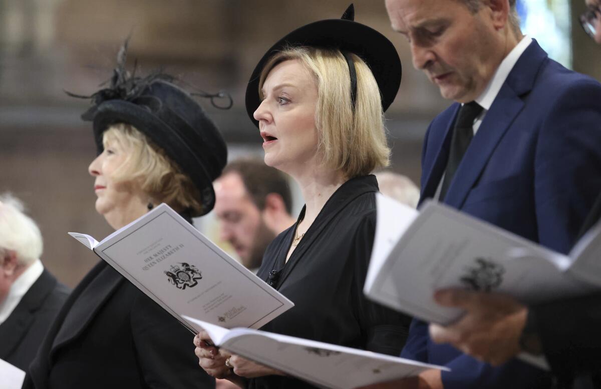 FILE - Britain's Prime Minister Liz Truss attends a memorial service for Britain's Queen Elizabeth II at St Anne's Cathedral in Belfast, Tuesday Sept. 13, 2022. British Prime Minister Liz Truss took office less than two weeks ago, impatient to set her stamp on government. The death of Queen Elizabeth II ripped up Truss’s carefully laid plans for the first weeks of her term, putting everyday politics in the U.K. on hold as the country was plunged into official and emotional mourning. (Liam McBurney/Pool via AP, File)