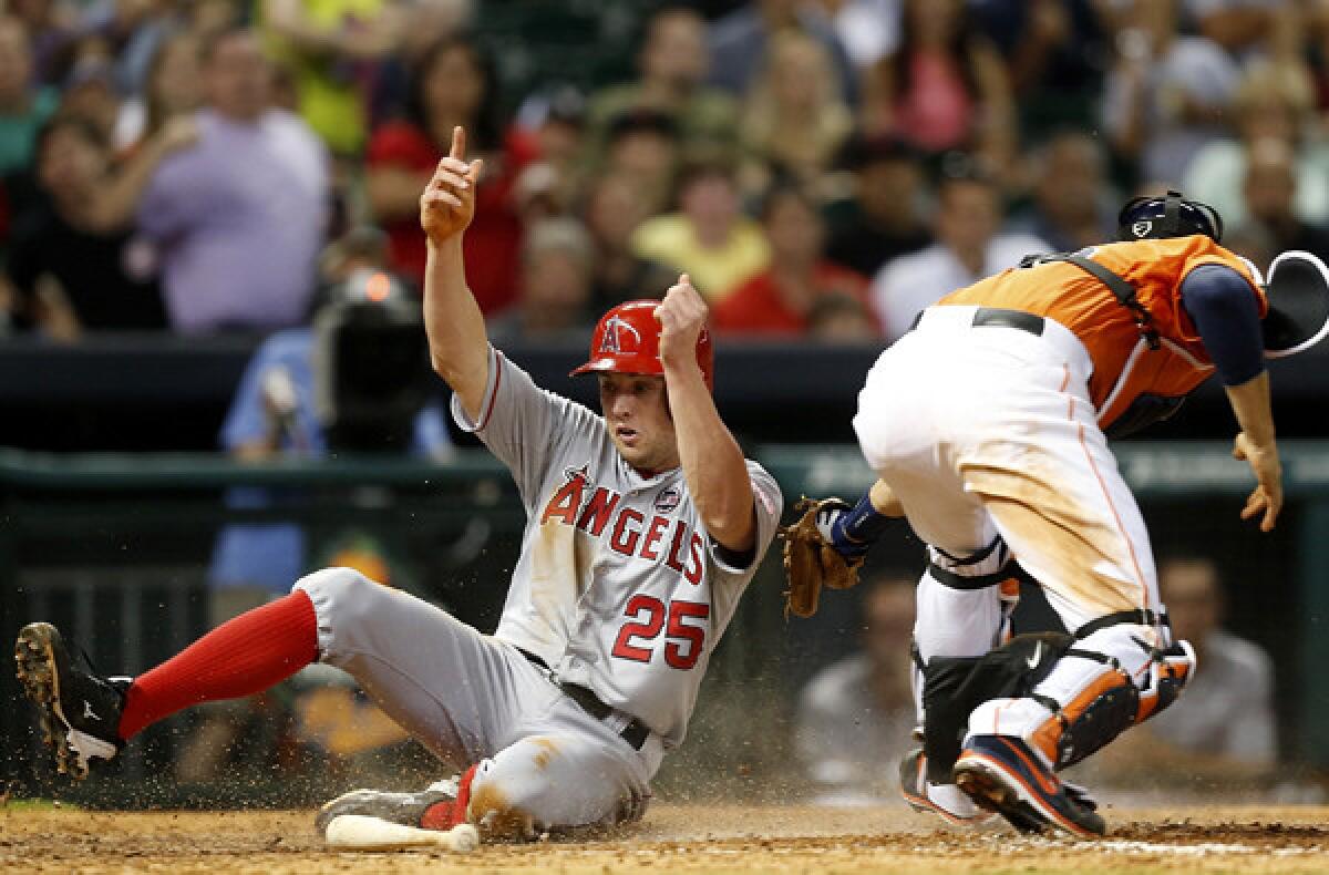 Angels outfielder Peter Bourjos scores in the eighth inning Friday night in Houston, beating the throw to Astros catcher Jason Castro. On Saturday, Bourjos was injured yet again.
