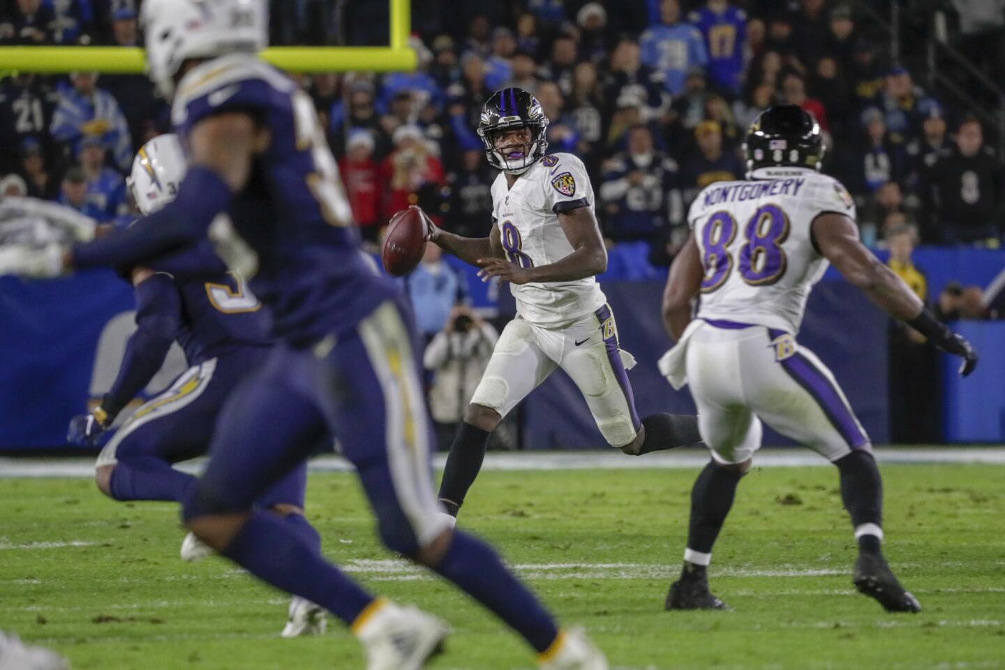 Ravens quarterback Lamar Jackson scrambles away from pressure during a second quarter drive at StubHub Center.